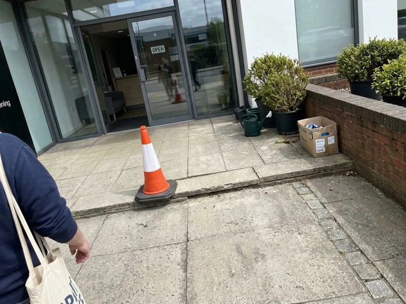 Commercial entrance walkway with a stepped joint across the accessible route