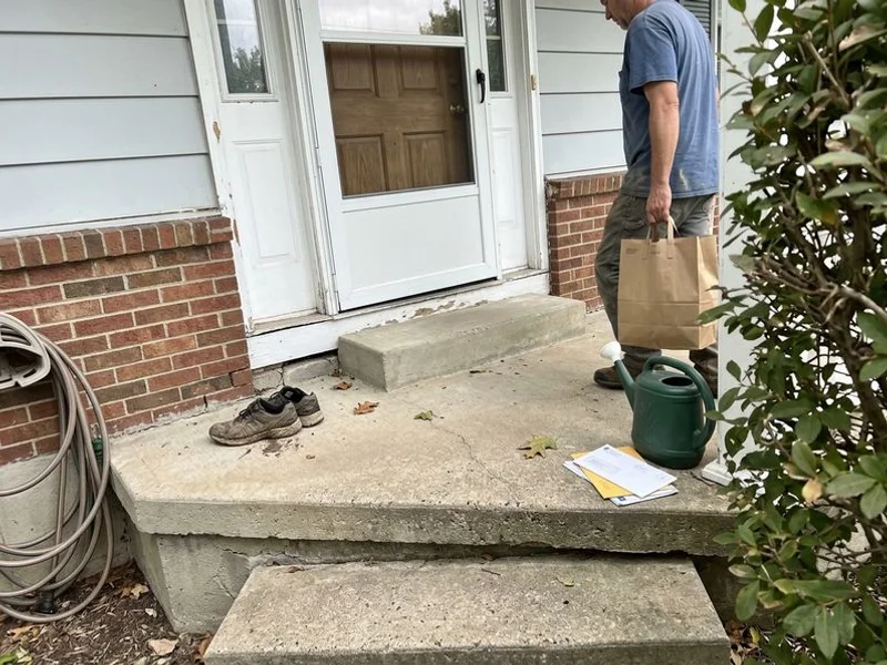 Front stoop with one corner visibly lower and the treads sloping to the side