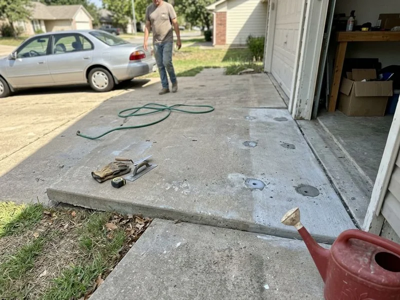 The same driveway lifted flush to the garage slab with patched ports
