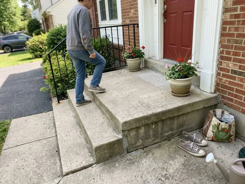 Stoop lifted level with the treads flat and the gap at the house closed